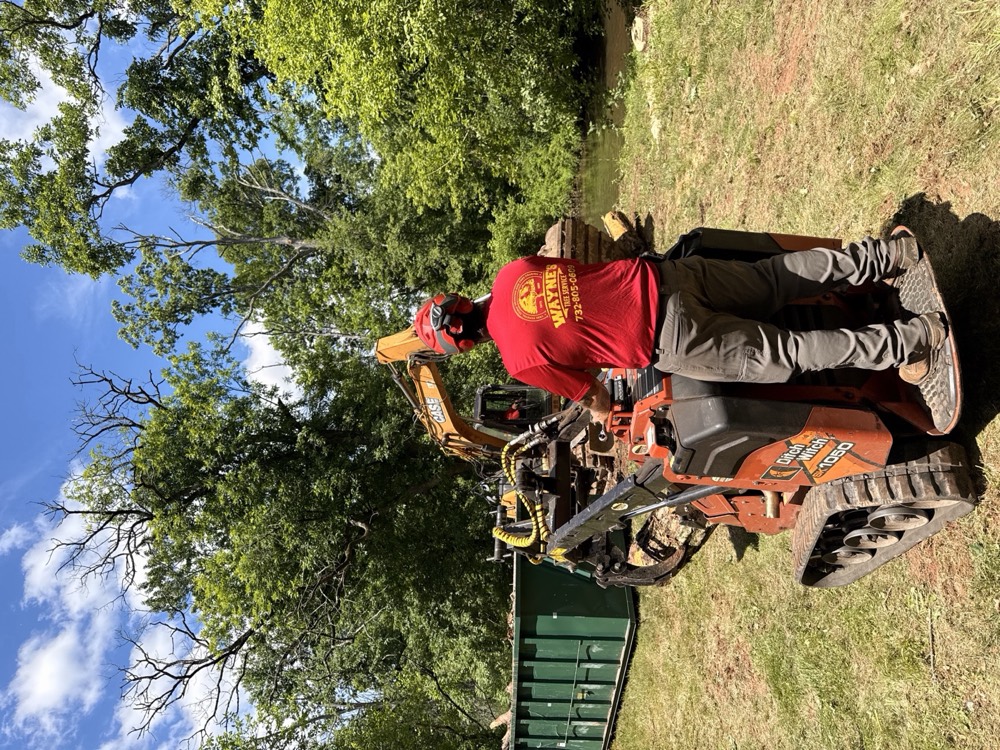 Crew member operating a compact tracked machine